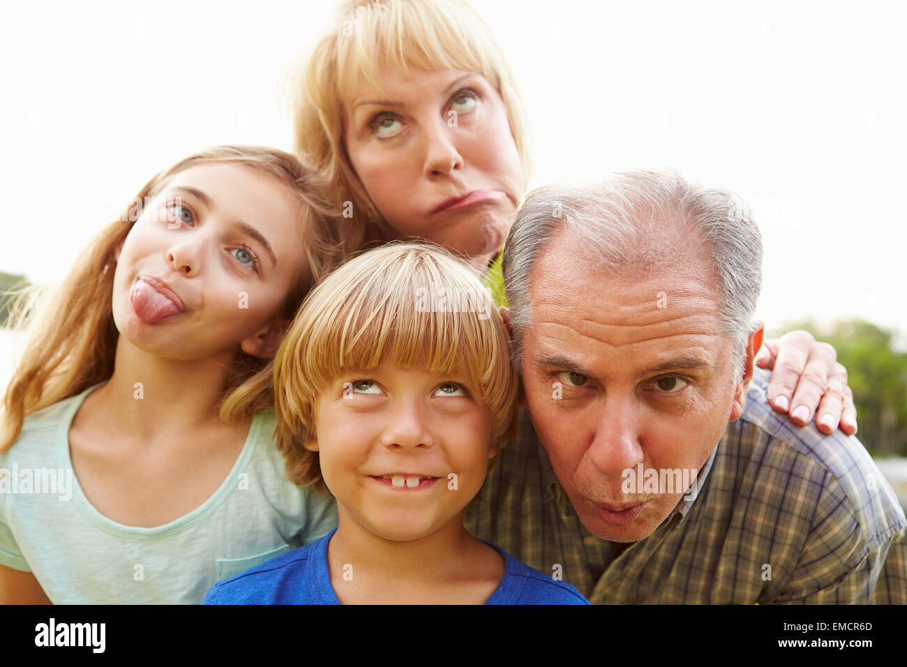 Grandparents And Grandchildren Pulling Funny Faces Stock Photo