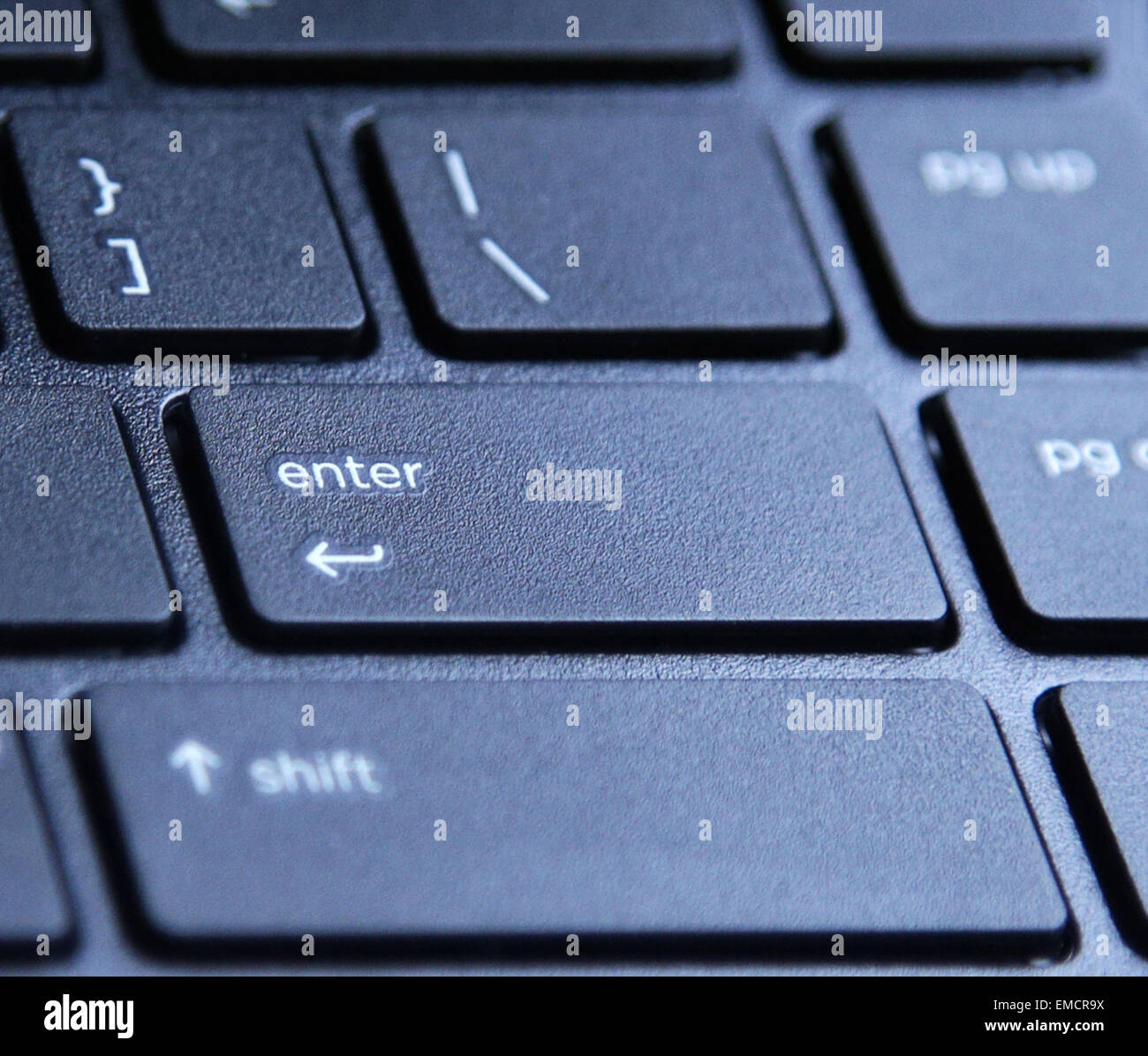 laptop computer keyboard with highlighted enter key button Stock Photo