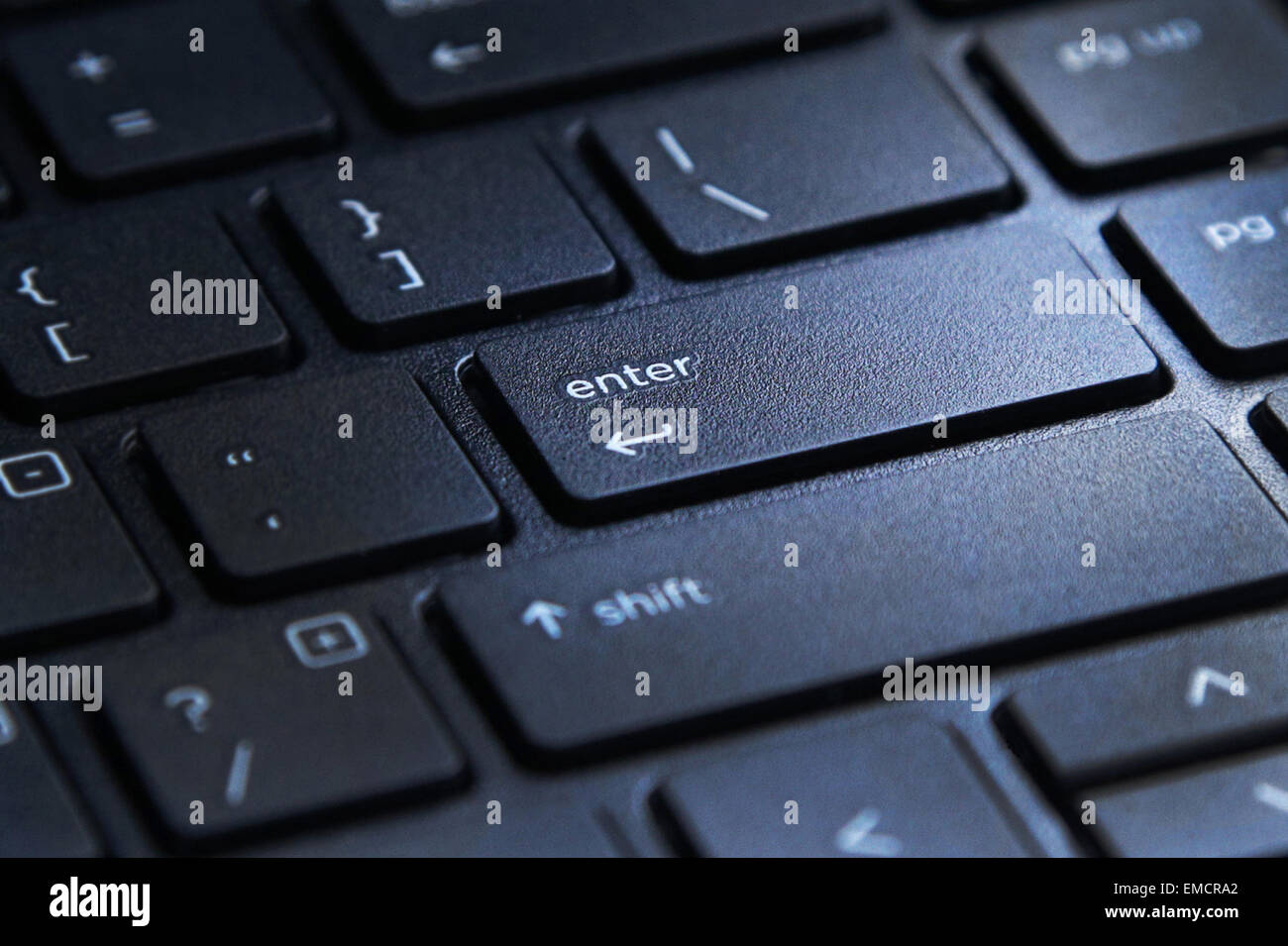 laptop computer keyboard with highlighted enter key button Stock Photo