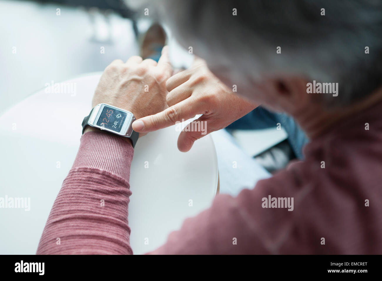 Man adjusting smartwatch Stock Photo