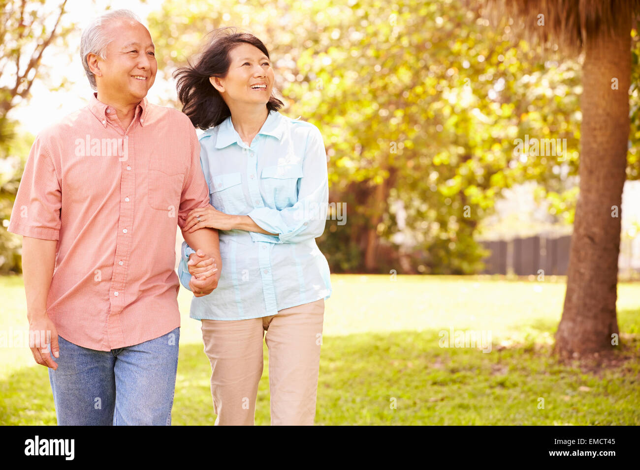 Senior Asian Couple Walking Through Park Together Stock Photo - Alamy