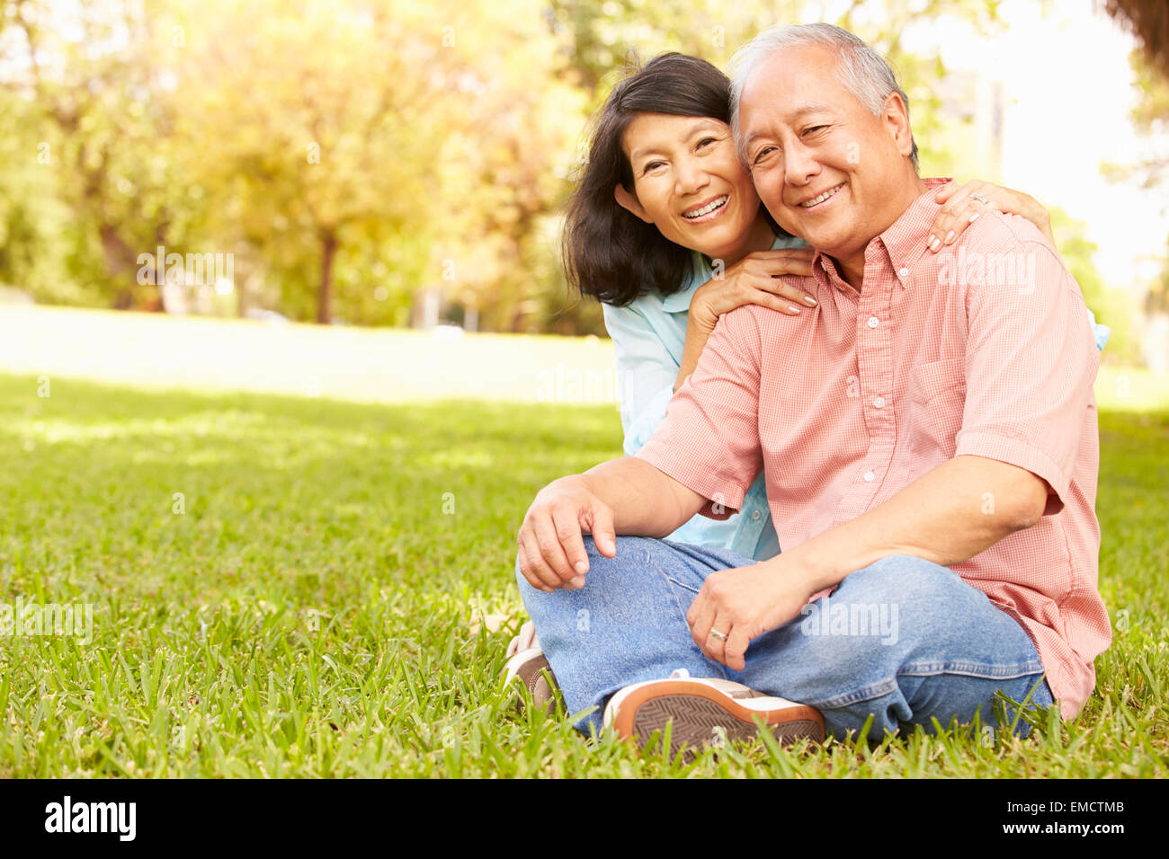 Portrait Of Senior Asian Couple Sitting In Park Together Stock Photo ...