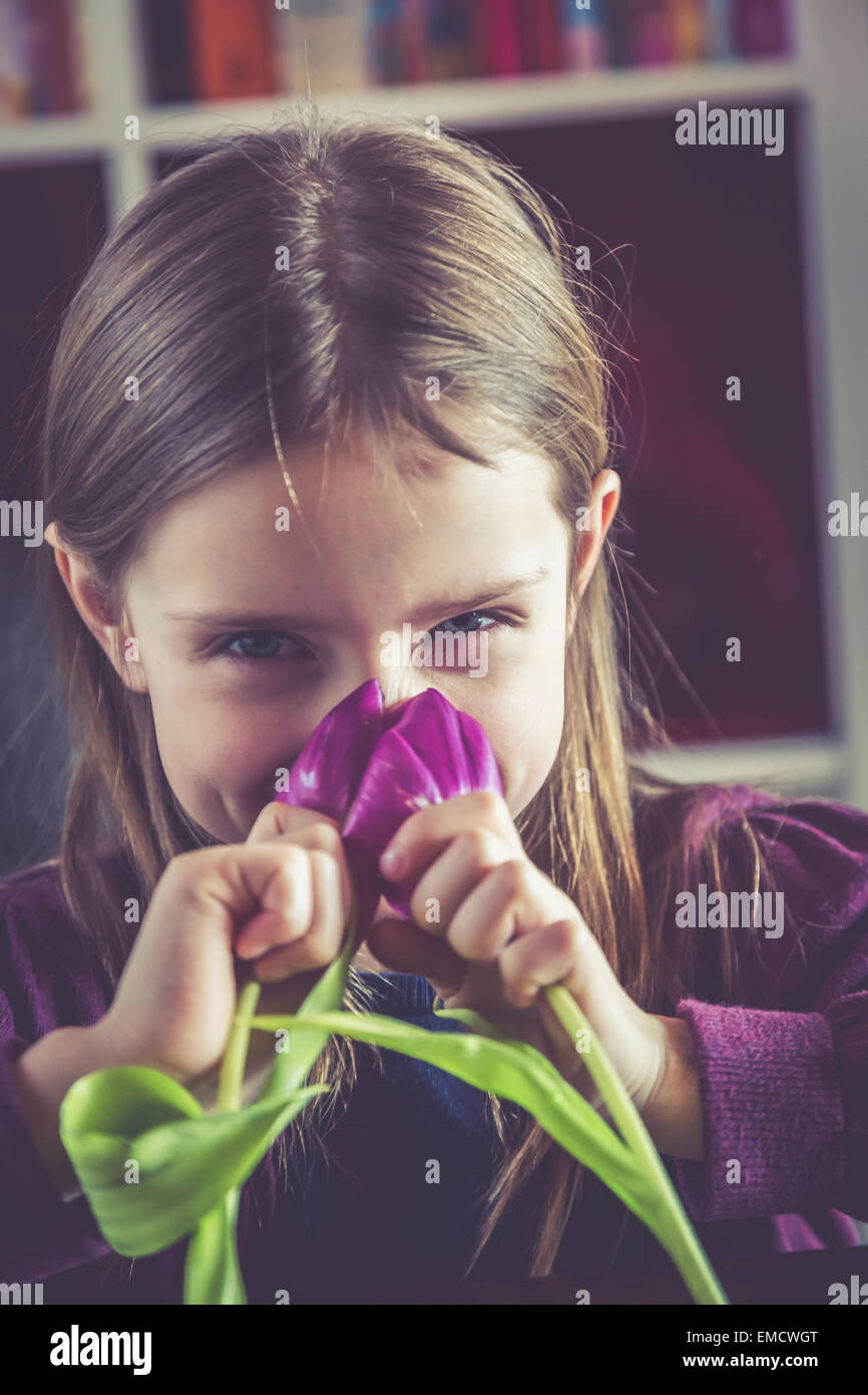 Little girl smelling tulips Stock Photo - Alamy