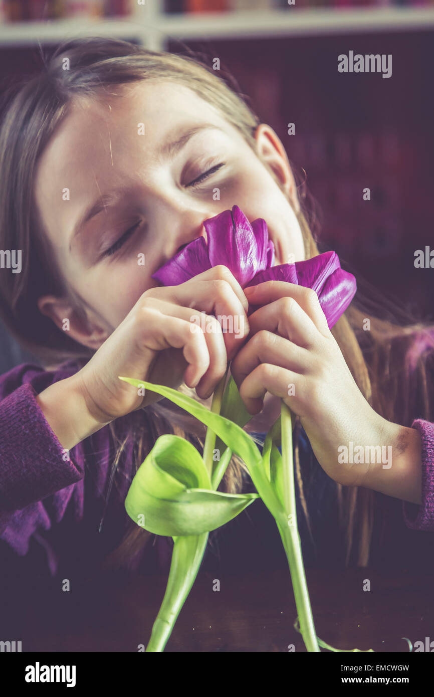 Little girl with closed eyes smelling tulips Stock Photo - Alamy