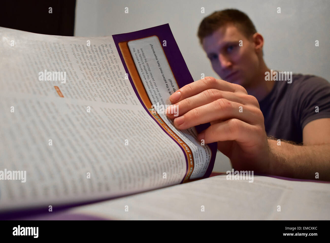 A college student studies for his final exams as a medical student. Stock Photo