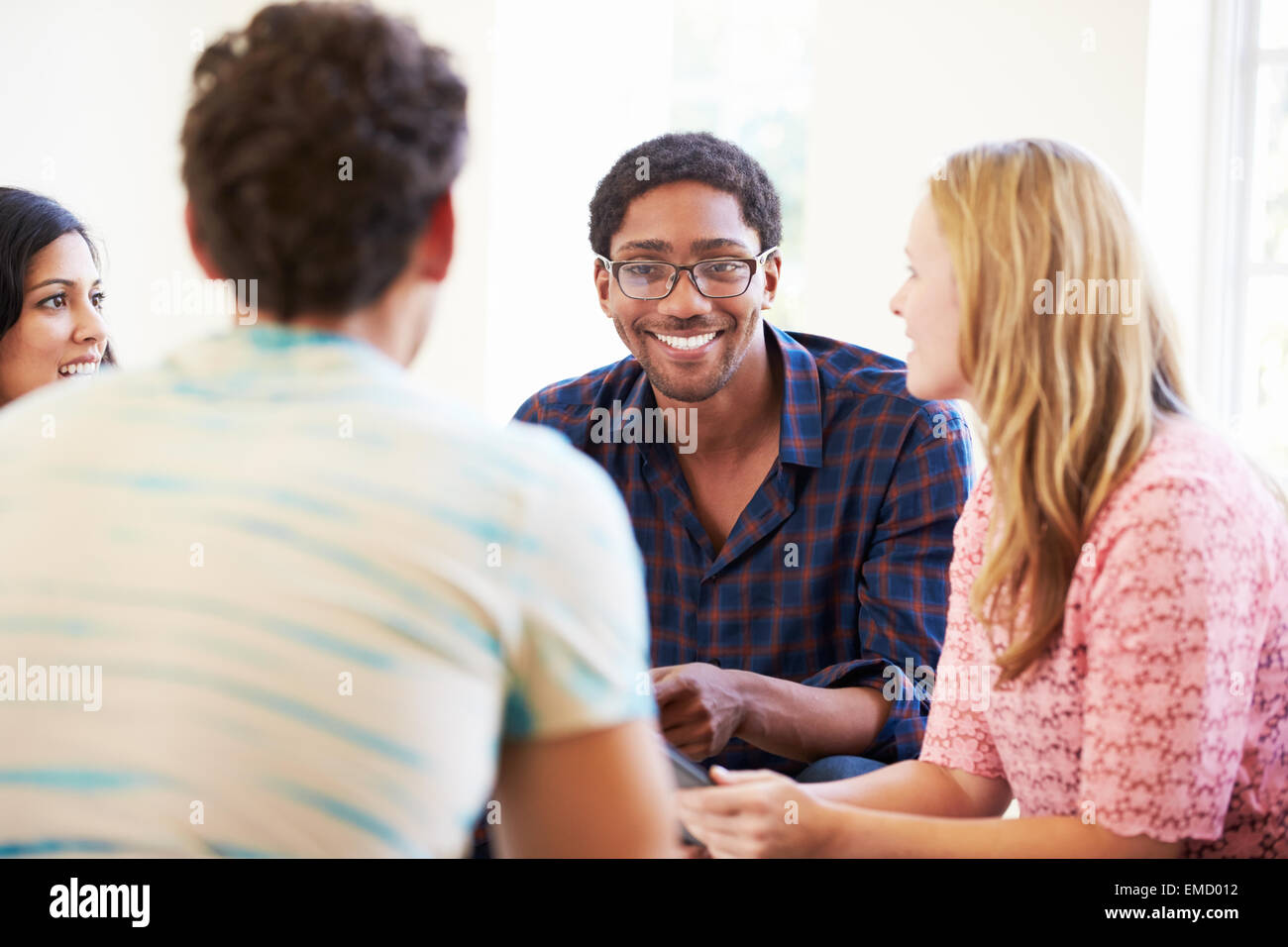 Group Of Business People Sitting On Chairs Having Meeting Stock Photo