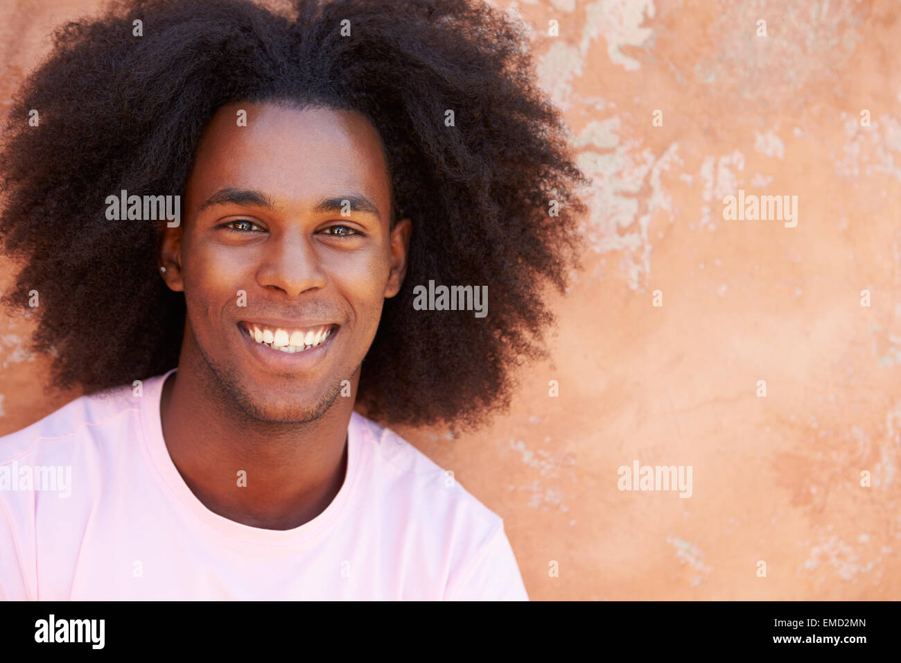 Portrait Of Smiling Man Leaning Against Wall Stock Photo - Alamy