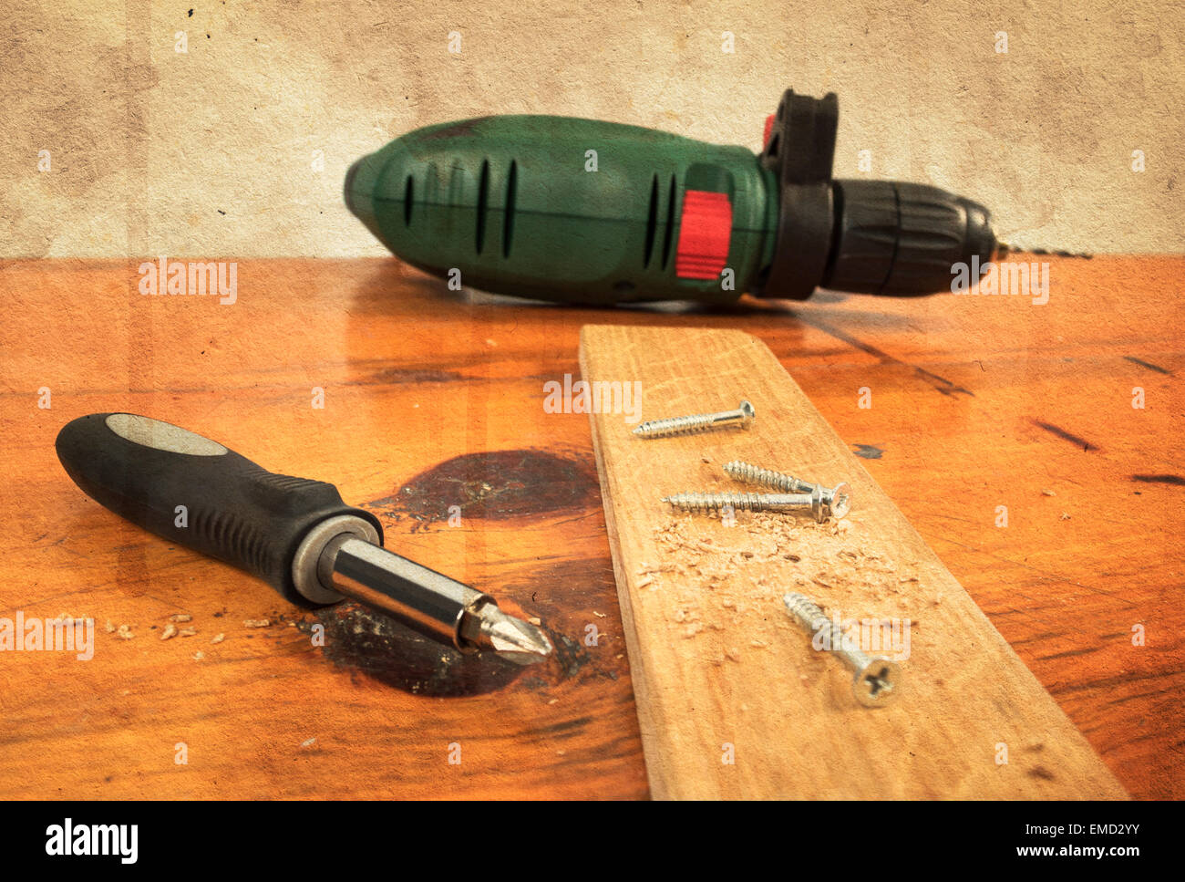 Metal workshop. Electric screwdriver, cordless drill on a wooden board Stock Photo