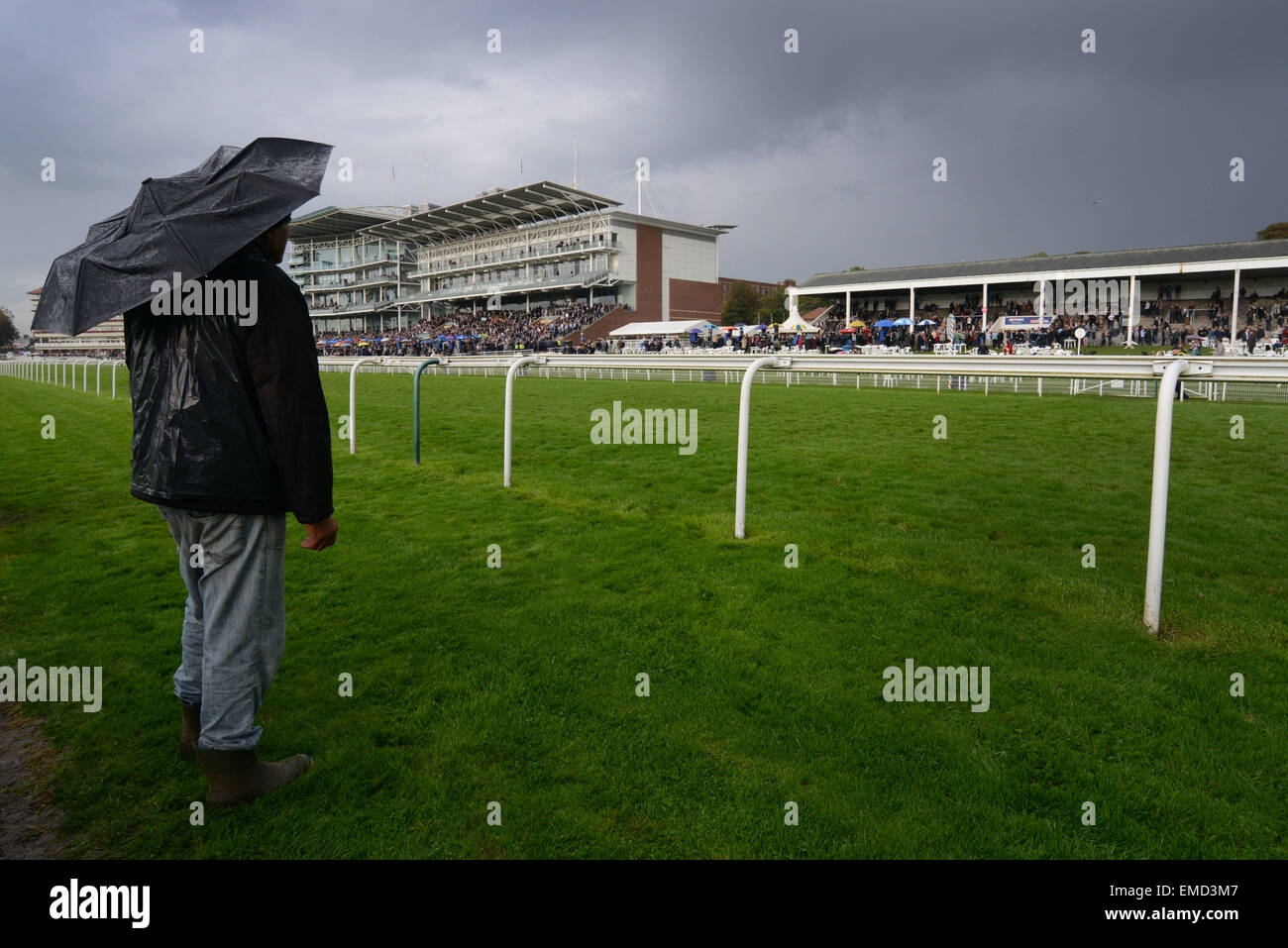 A spectator watching the racing at York Racecourse, North Yorkshire, UK. Picture: Scott Bairstow/Alamy Stock Photo