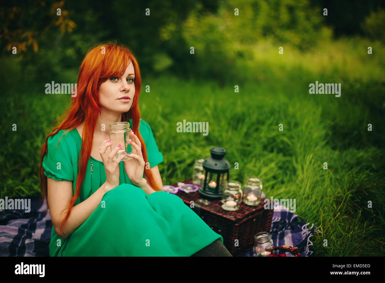 Beautiful Red Hair Girl With Deep Green Eyes Sitting In Grass