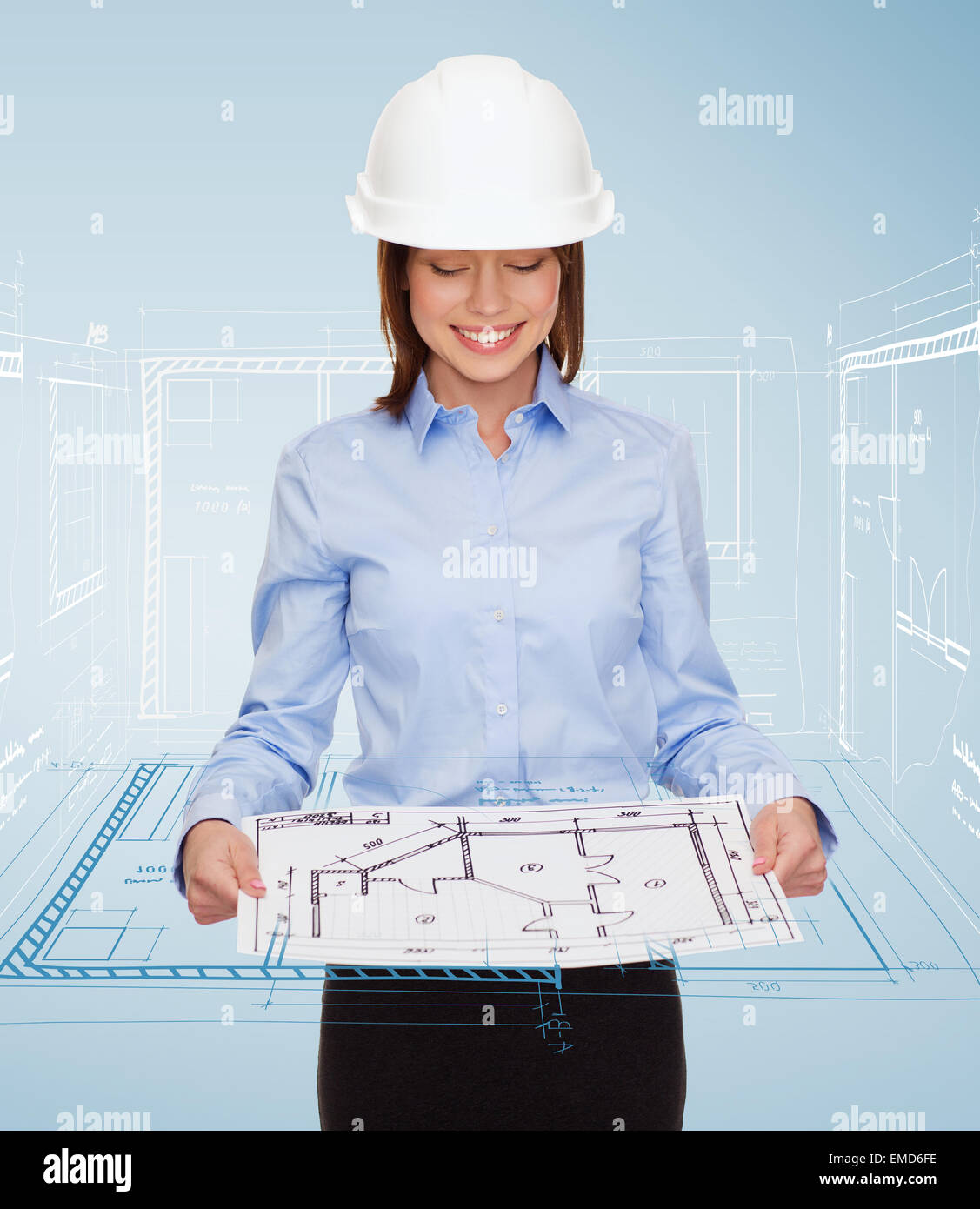 businesswoman in helmet looking at blueprint Stock Photo - Alamy