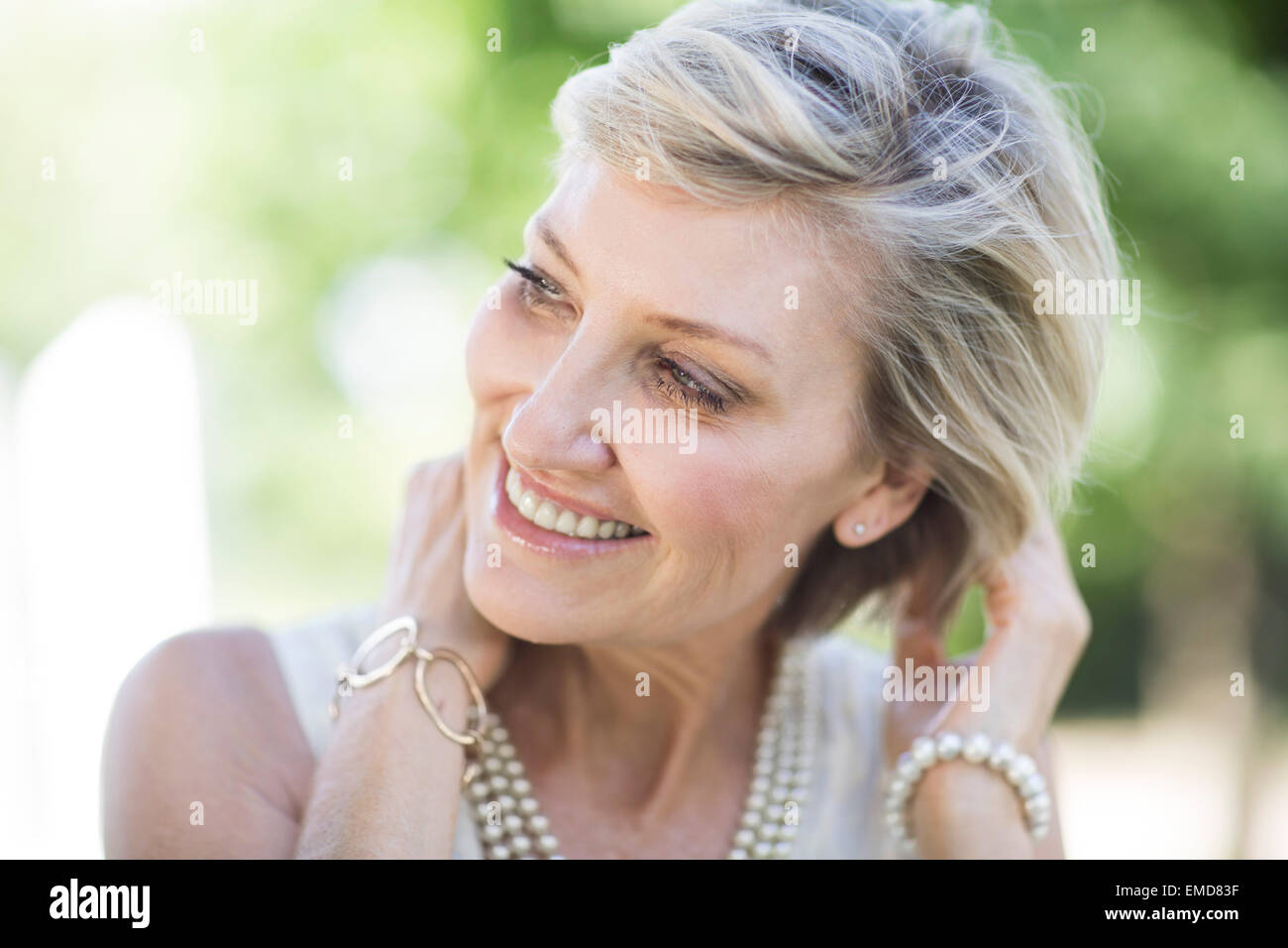 Portrait of smiling mature woman outdoors Stock Photo - Alamy