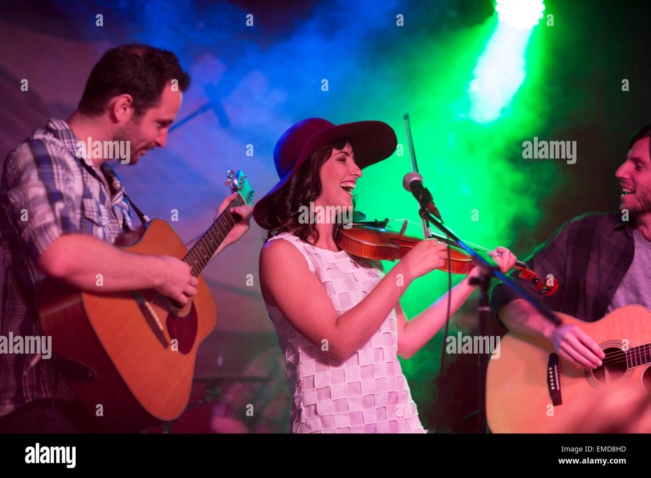 Folk band with violin and two acoustic guitars Stock Photo Alamy