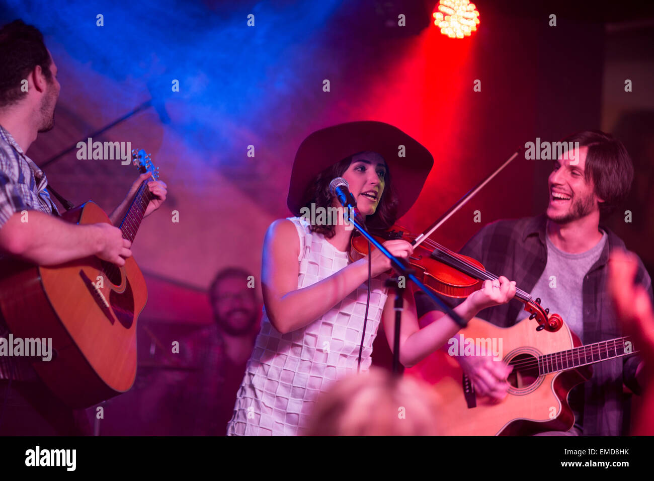 Folk band with violin, two acoustic guitars and a drummer Stock Photo Alamy