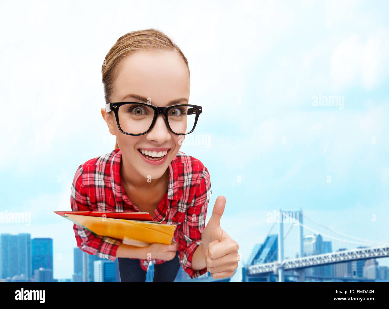 student in glasses with folders showing thumbs up Stock Photo - Alamy