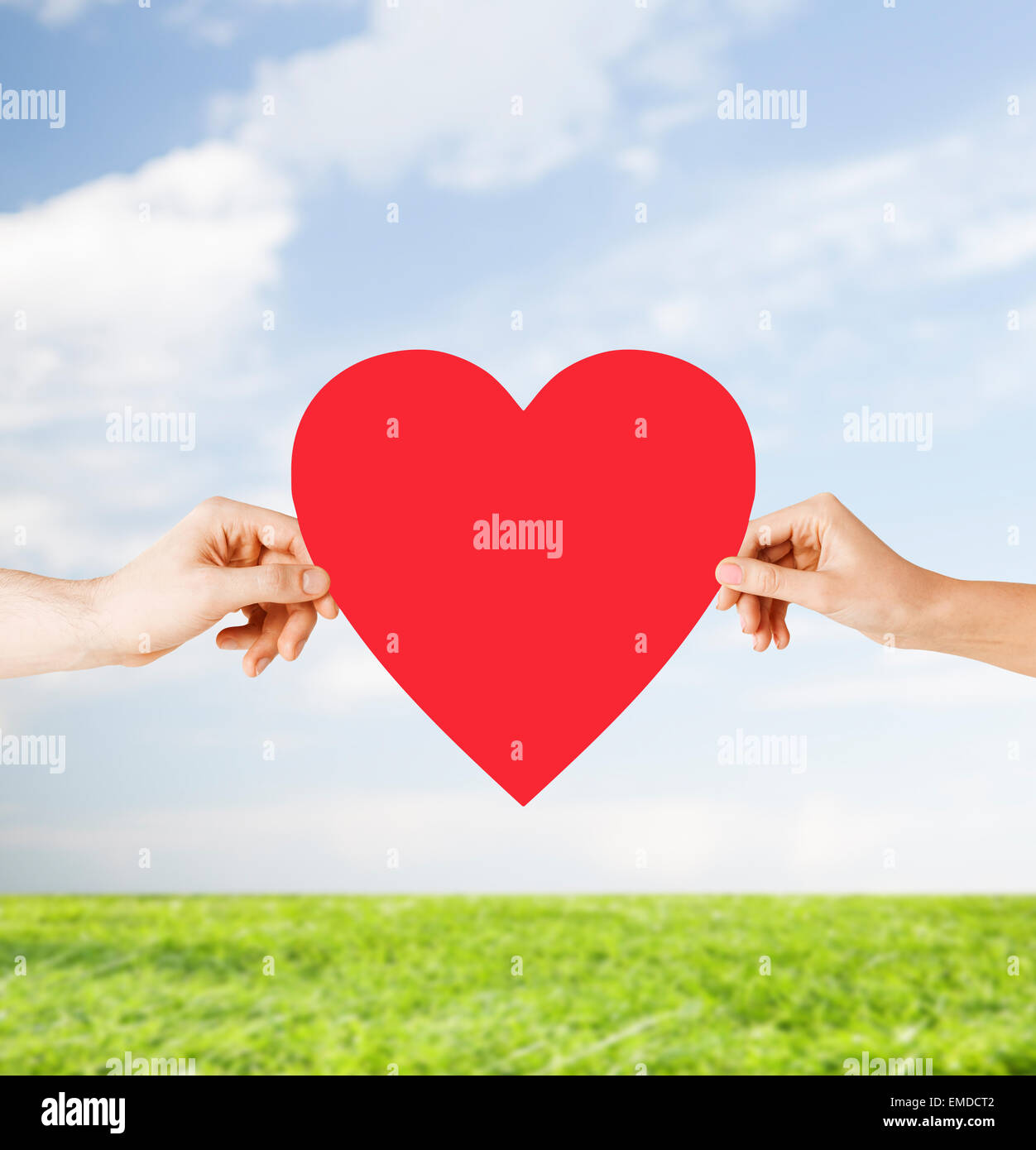 couple hands holding red heart Stock Photo - Alamy