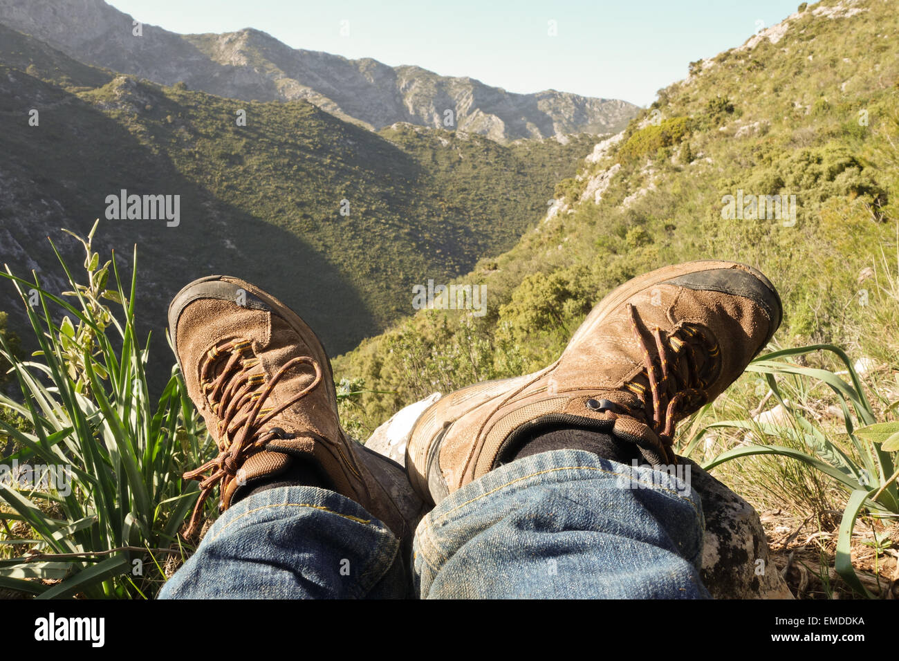 Hiking Boots, Shoes. Mountain range of Ojen in background, Andalusia, Southern Spain. Stock Photo