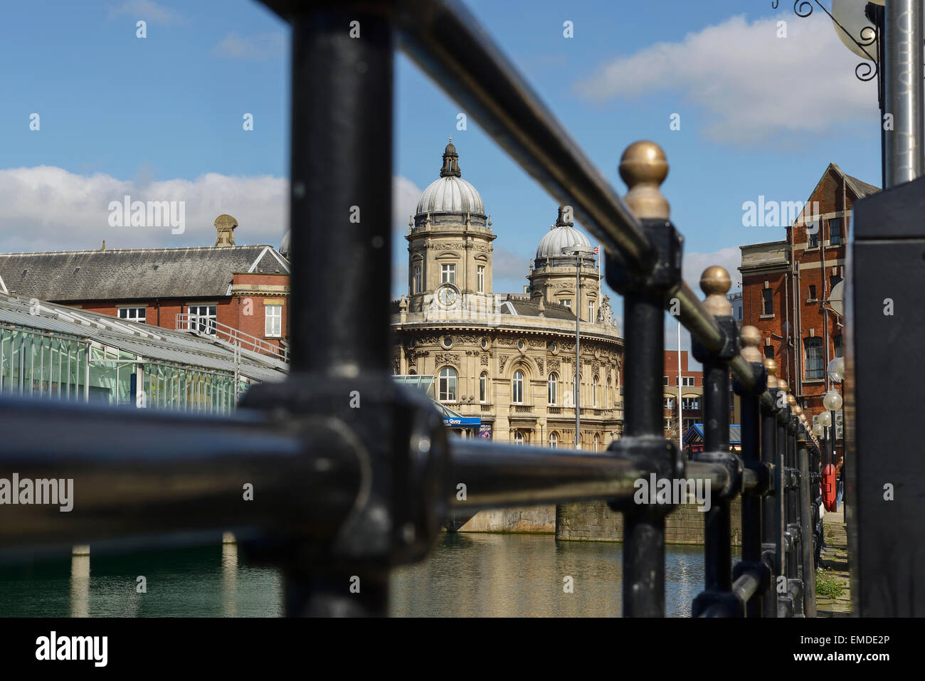 The Maritime Museum viewed through railings alongside the Princes Quay Shopping Centre and Princes Dock in Hull city centre UK Stock Photo
