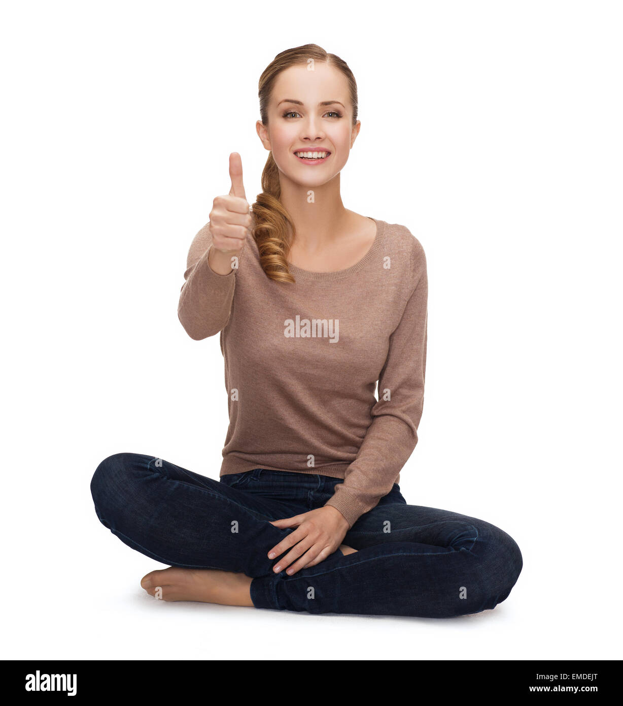 smiling young woman sitting on floor Stock Photo - Alamy