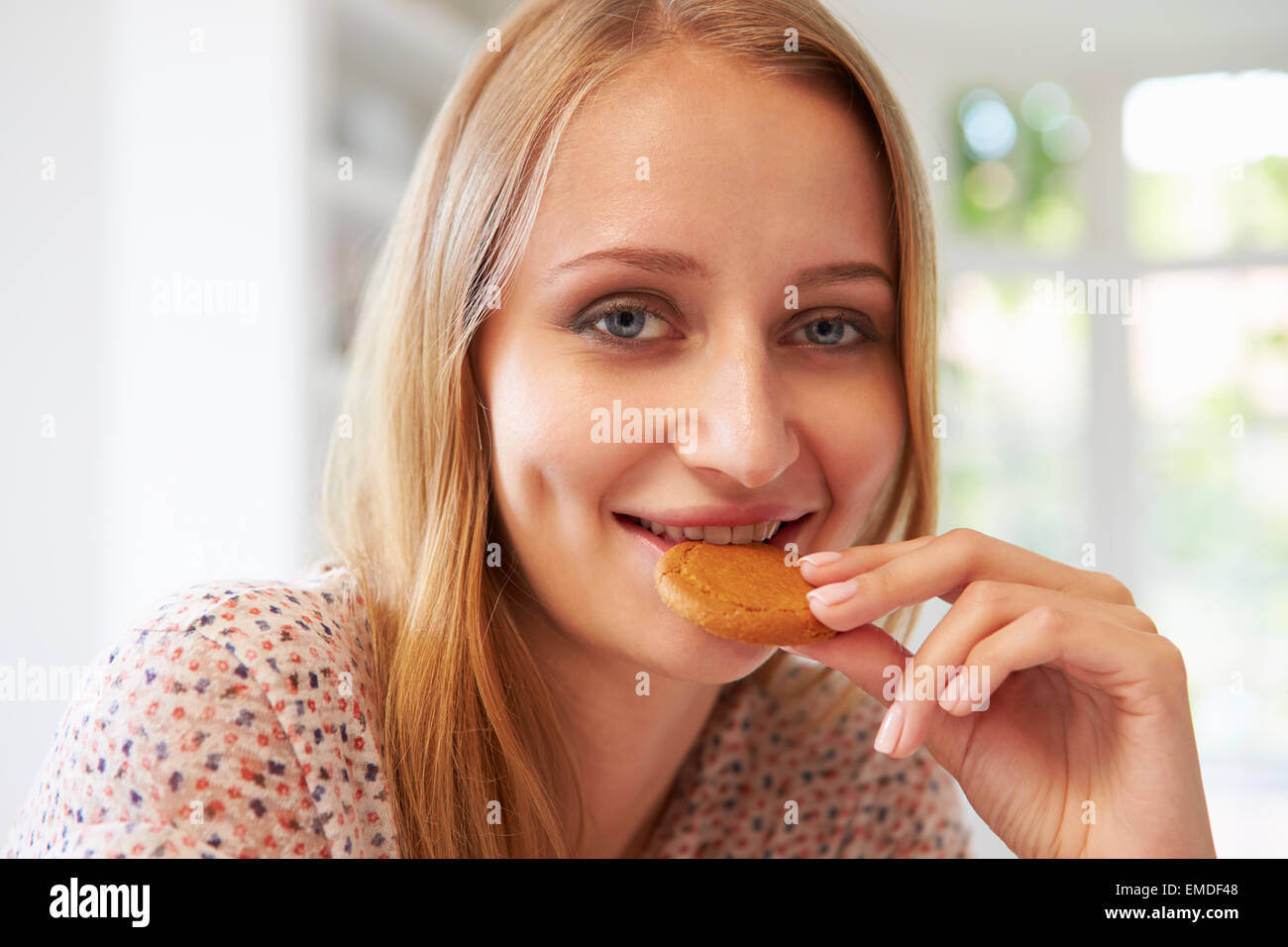Woman Eats Ginger Biscuit To Stop Nausea Of Morning Sickness Stock Photo