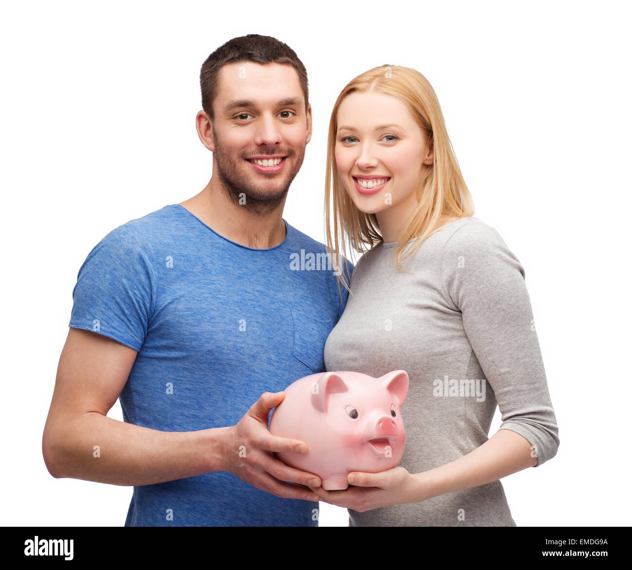 smiling couple holding big piggy bank Stock Photo - Alamy