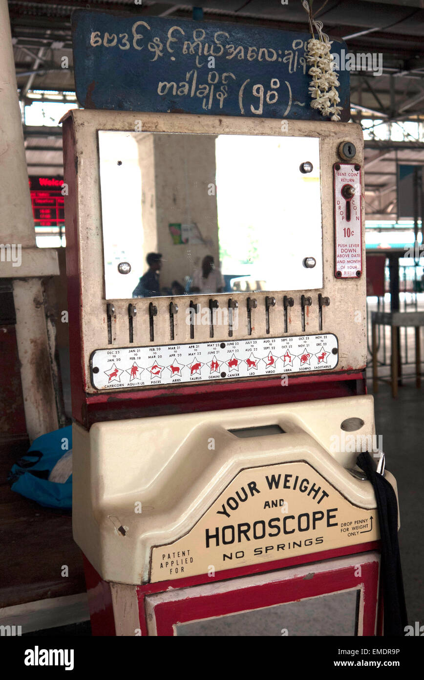 Multi-functional weight and horoscope slot machine, Main Railway Station, Yangon, Myanmar Stock Photo