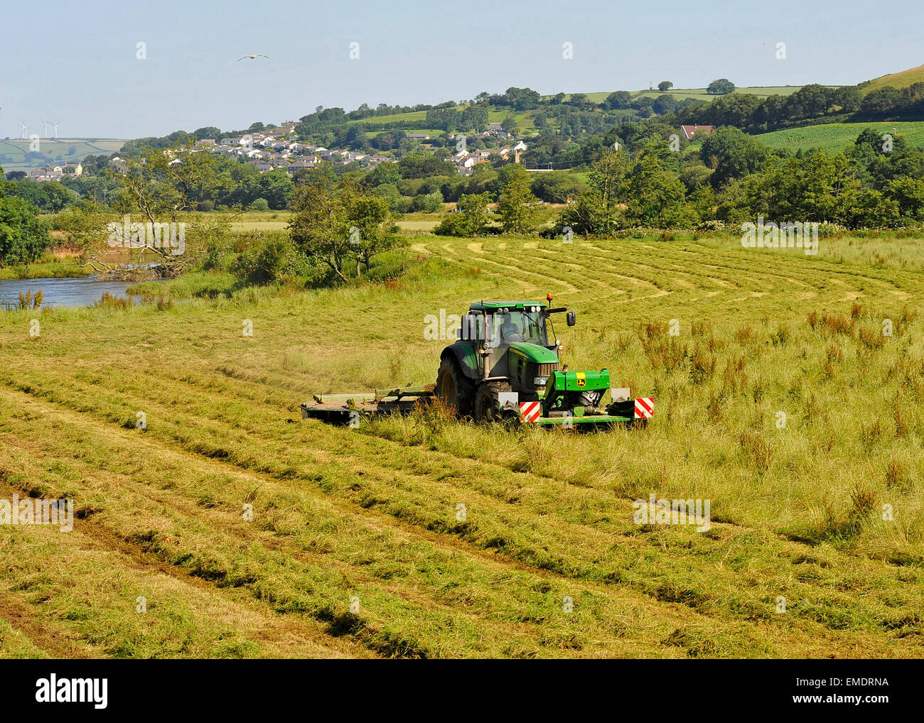 Farmer Grass Cutting by the River Taw North Devon Stock Photo Alamy
