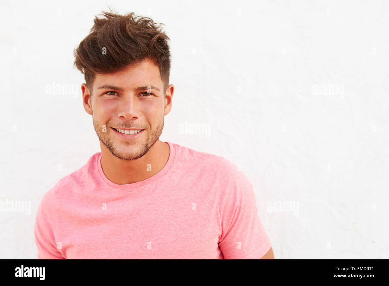 Portrait Of Young Man Standing Outdoors Against White Wall Stock Photo ...