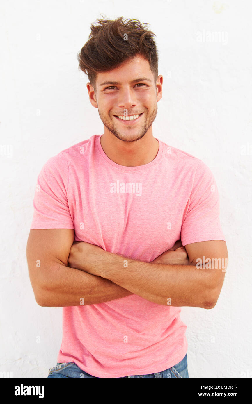 Portrait Of Young Man Standing Outdoors Against White Wall Stock Photo ...