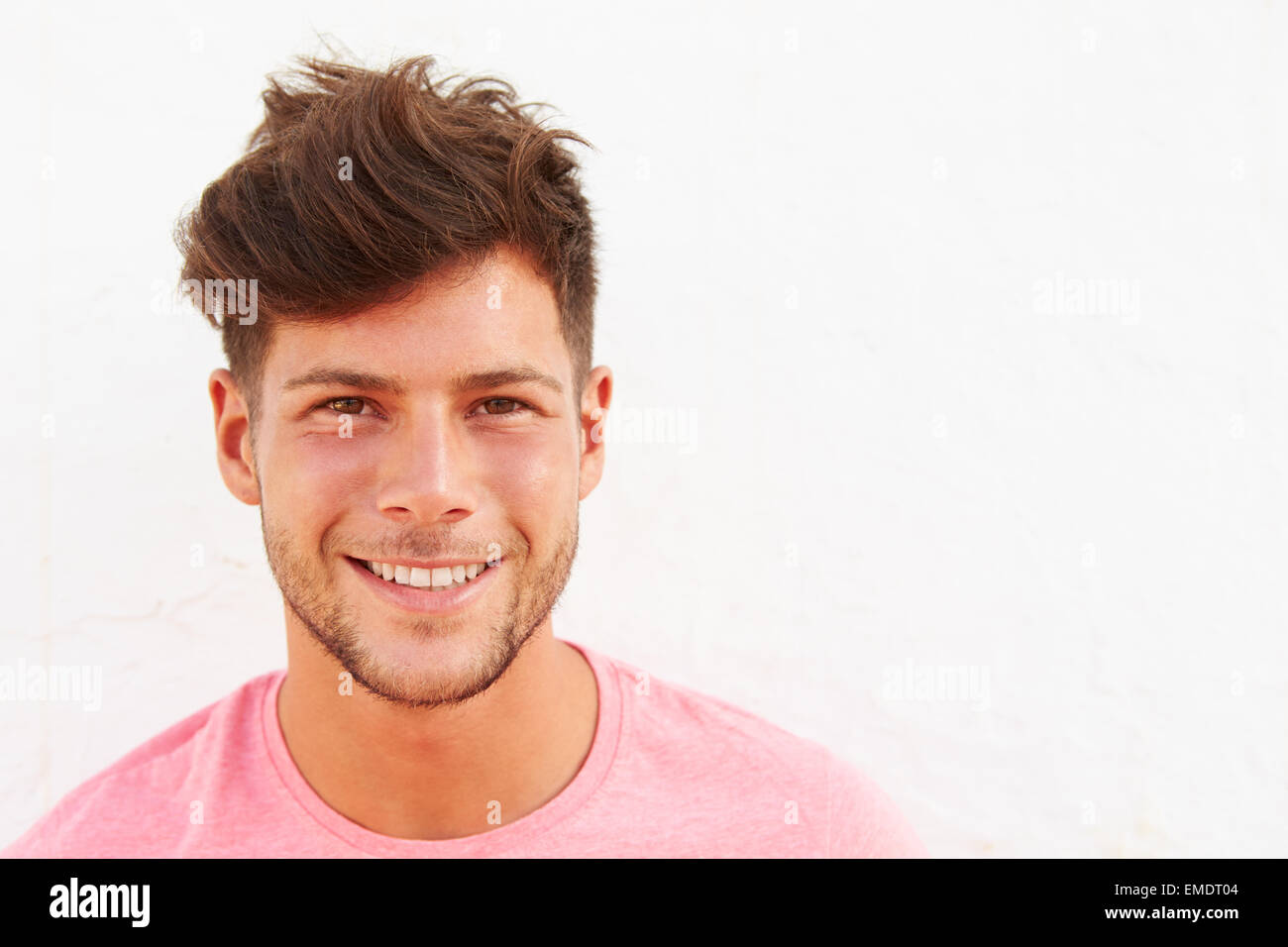 Portrait Of Young Man Standing Outdoors Against White Wall Stock Photo ...