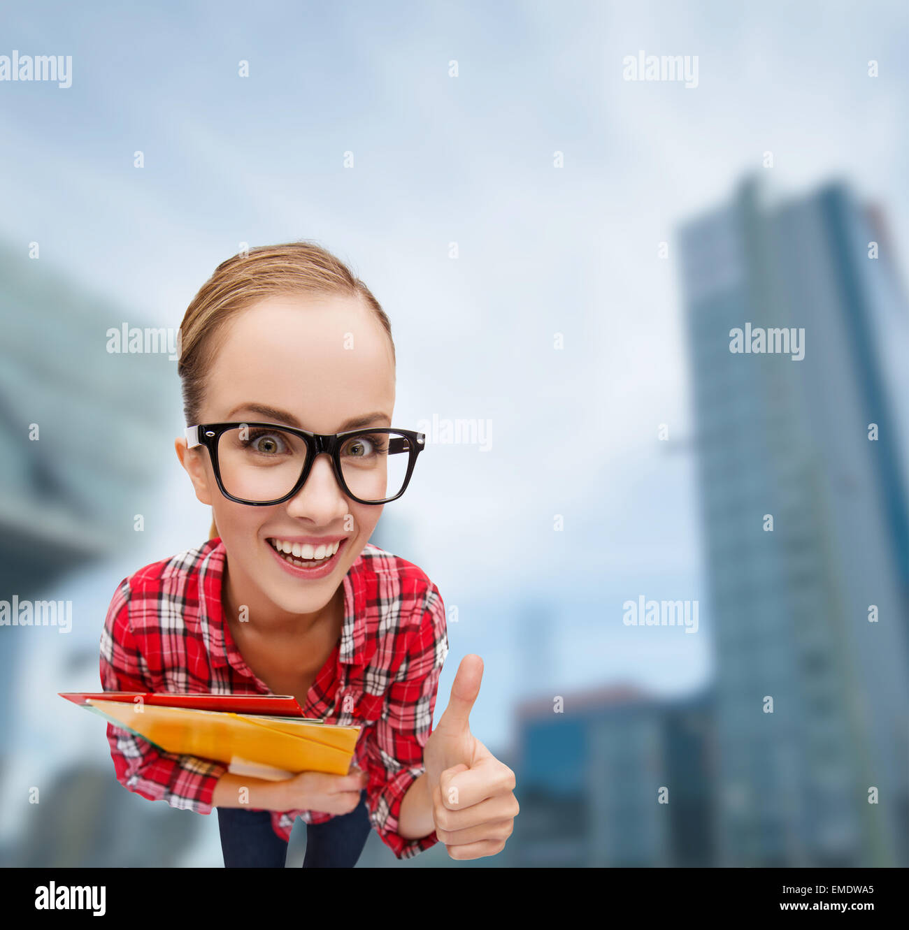 student in glasses with folders showing thumbs up Stock Photo - Alamy