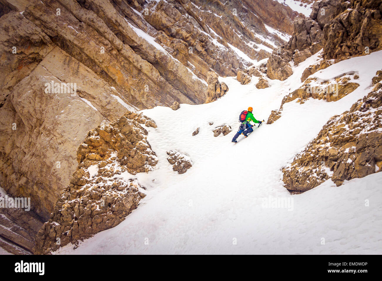 Mountaineer climbing a steep slope. Stock Photo