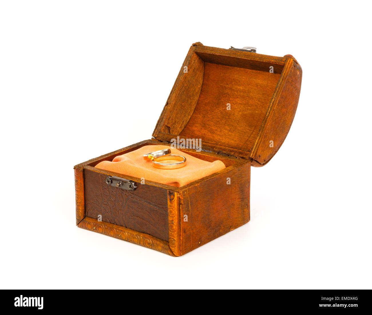 Two wedding rings in open treasure box against white background Stock