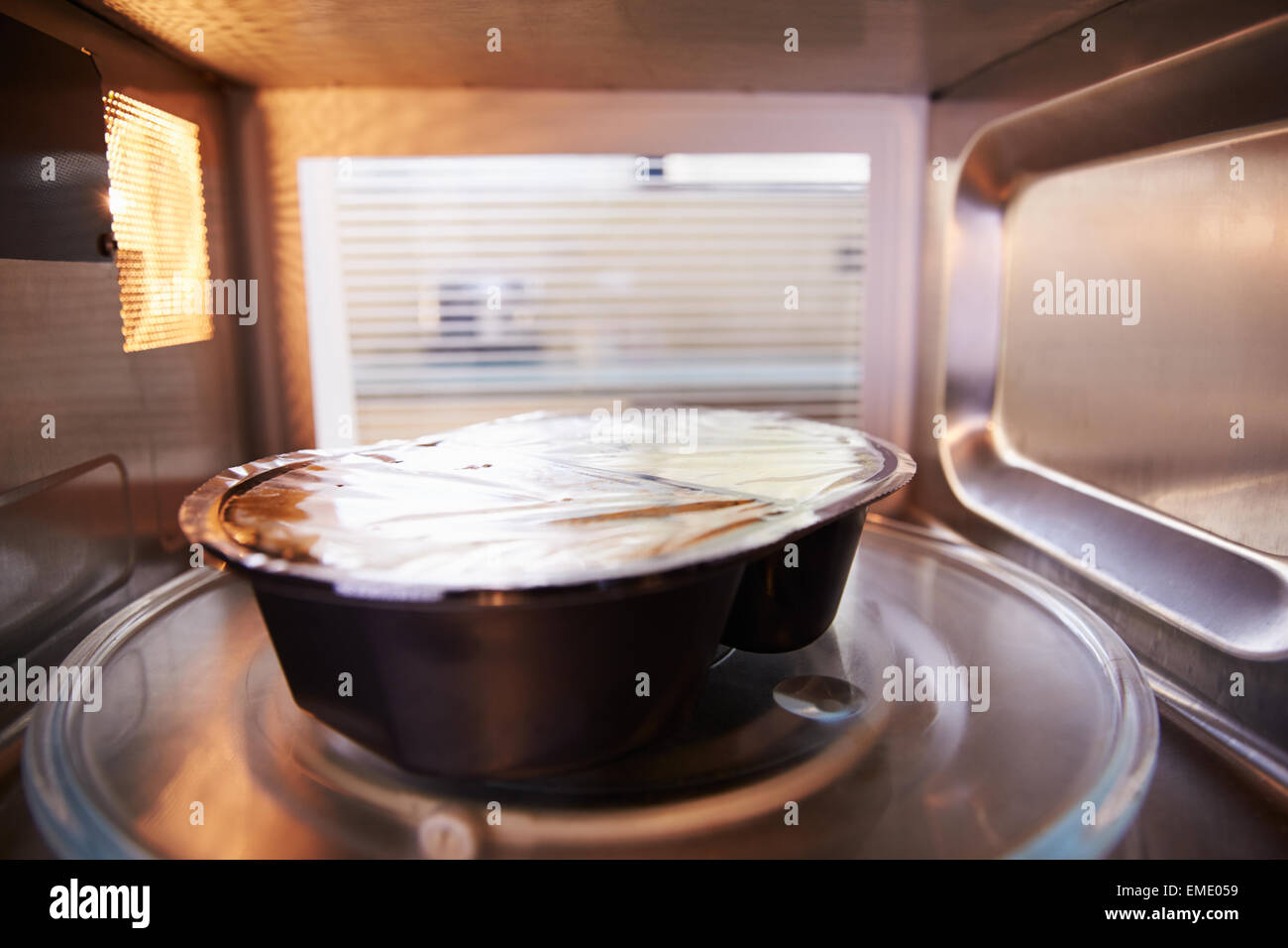 TV Dinner Cooking Inside Microwave Oven Stock Photo