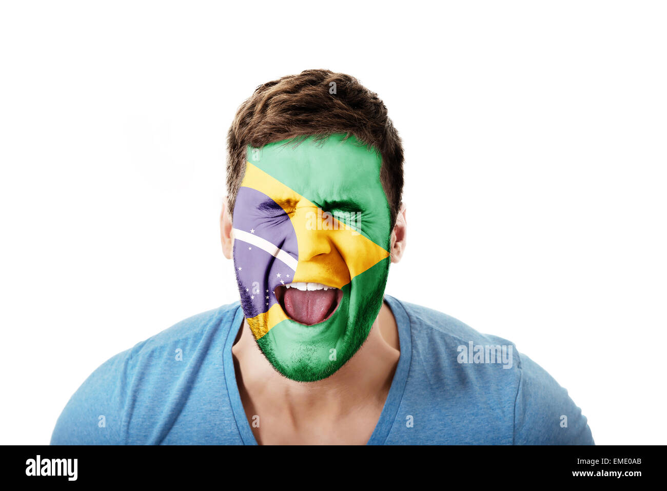 Screaming man with Brasil flag on face. Stock Photo