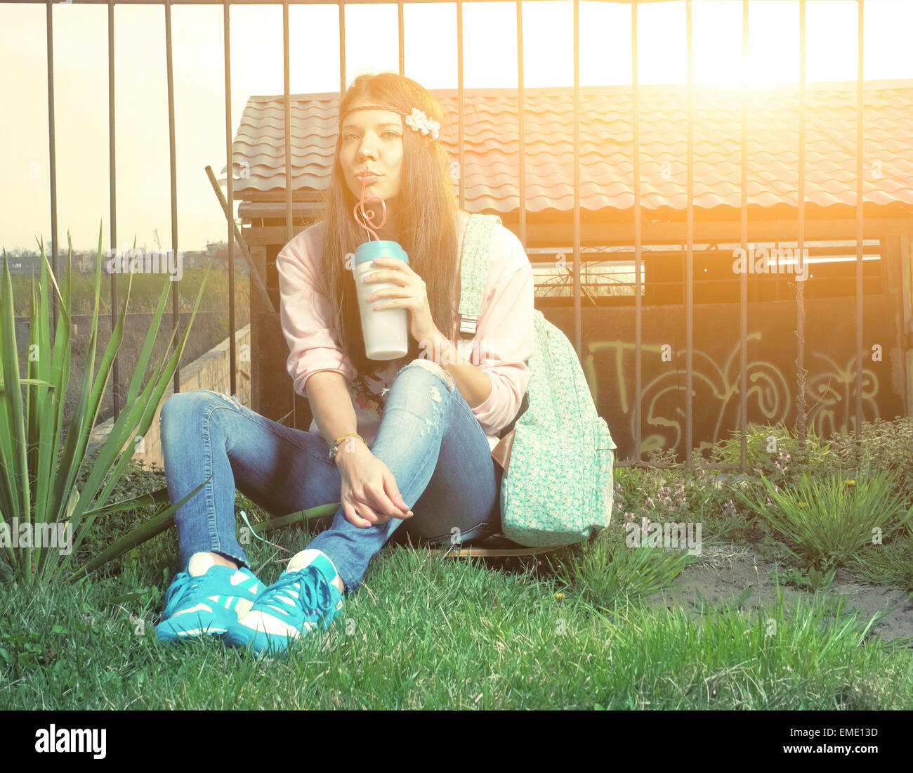 Happy young latina teenage woman  holding a takeaway coffee cup smiling. Outdoors summer portrait of beautiful teenage girl Stock Photo