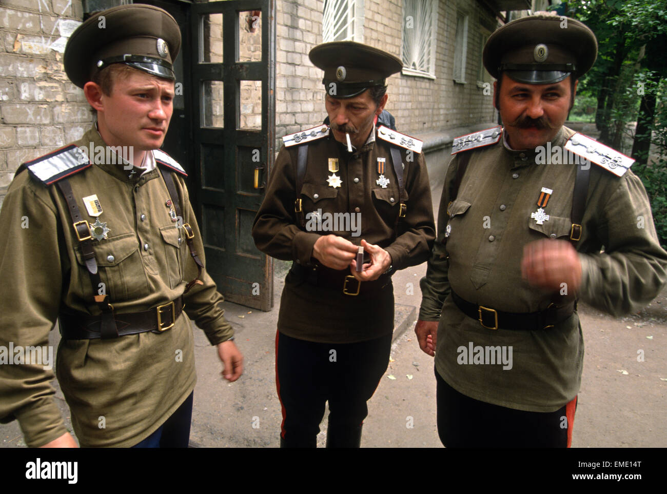 A Russian Don Cossack family gather outside their apartment building in Rostov-on-Don, Russia. The men are participating in the annual Cossack Festival gathering of units from around Russia. Stock Photo