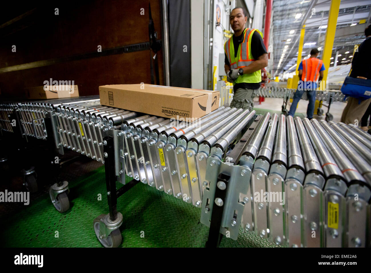 Amazon shipping center uses  advance tracking system to package orders and place into large tractor trailers for delivery Stock Photo