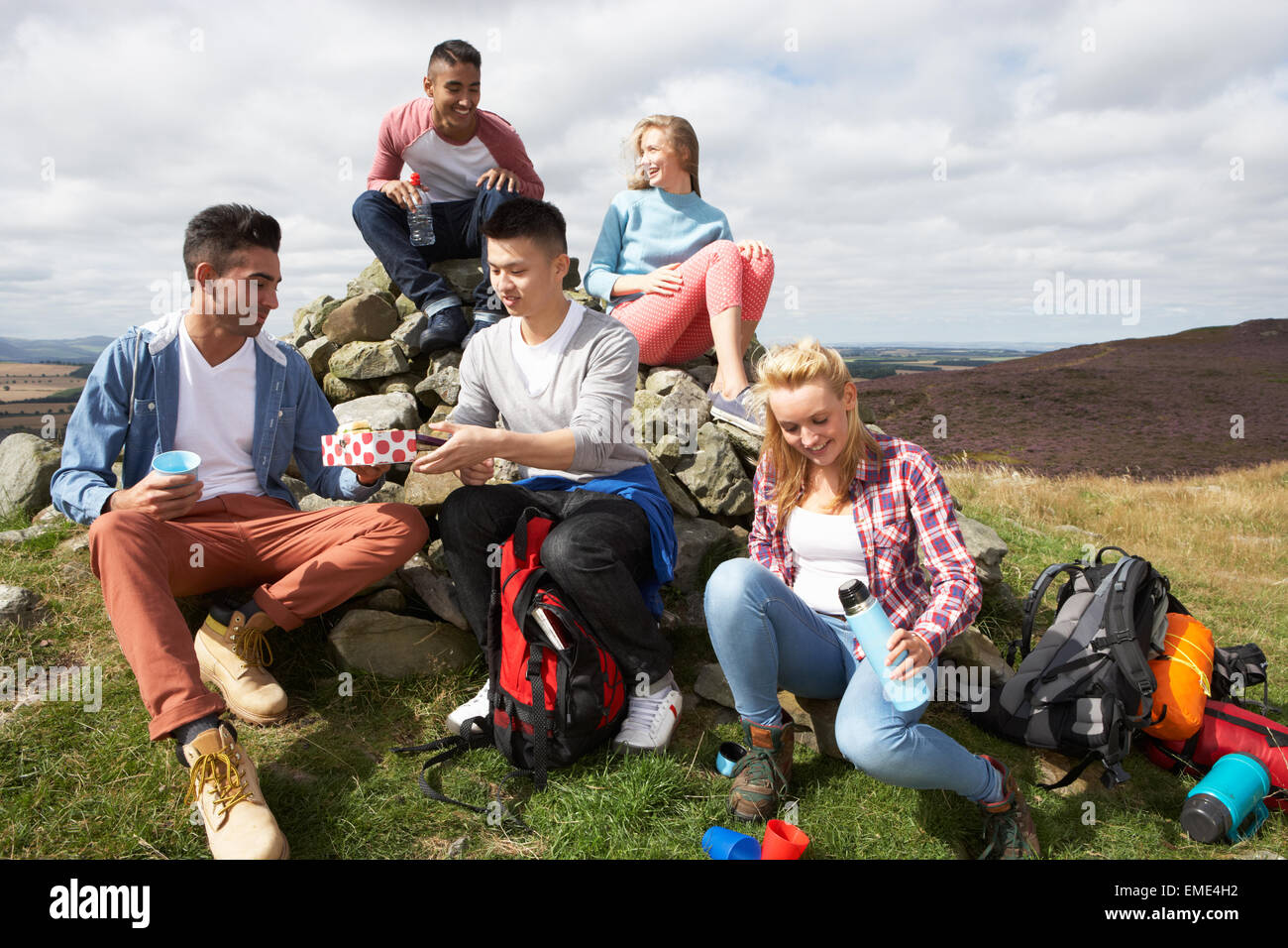 Group Of Young People Hiking In Countryside Stock Photo - Alamy