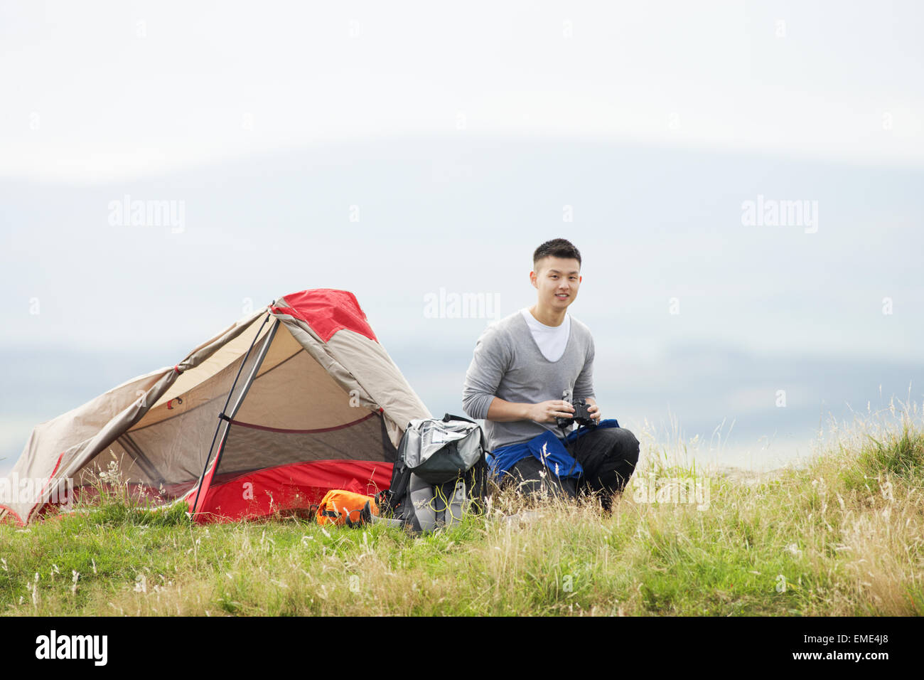 Young Man On Camping Trip In Countryside Stock Photo