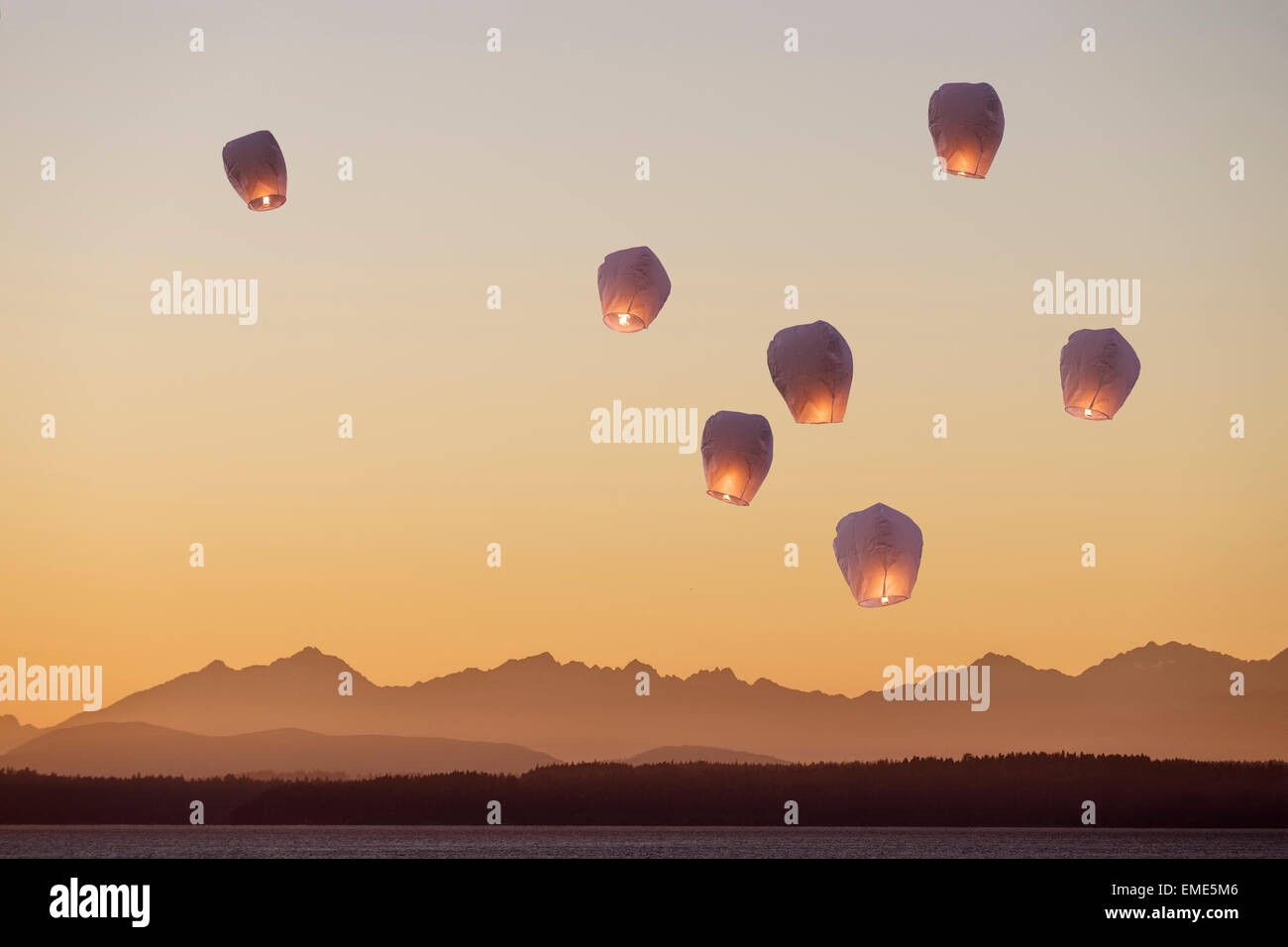 A group of flying lanterns being released into the nightsky Stock Photo