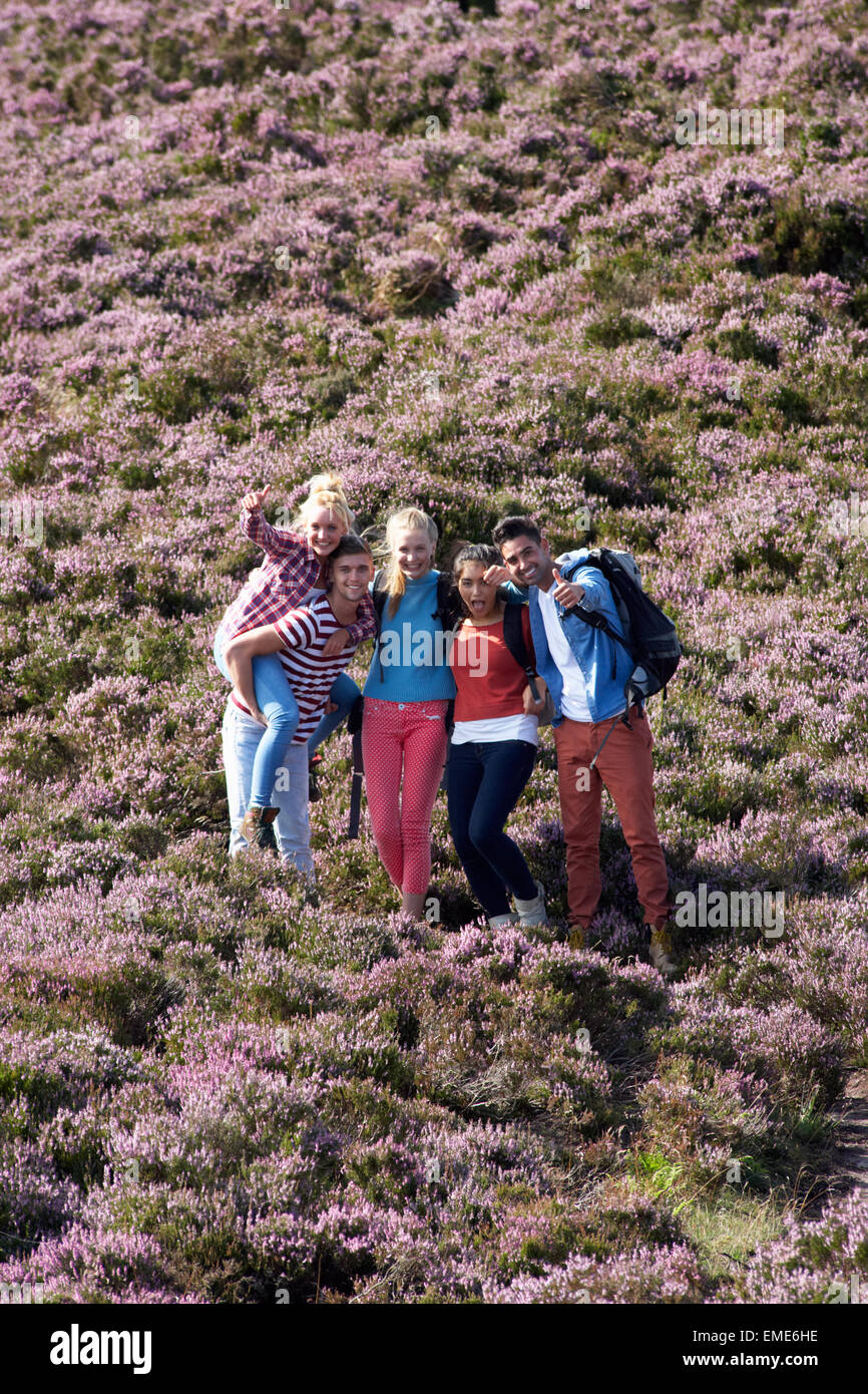 Group Of Young People Hiking Through Countryside Stock Photo - Alamy