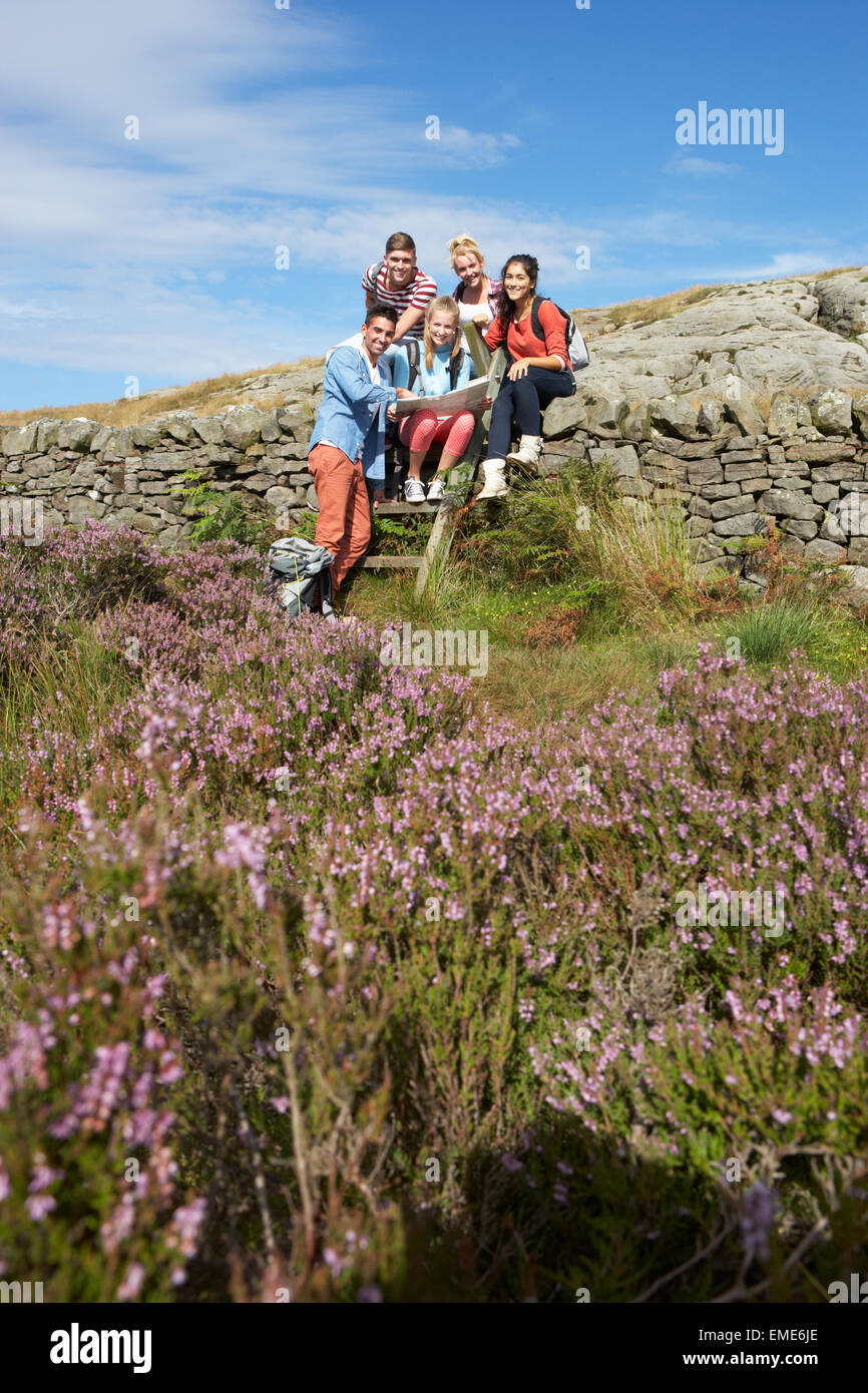 Group Of Young People Hiking Through Countryside Stock Photo - Alamy