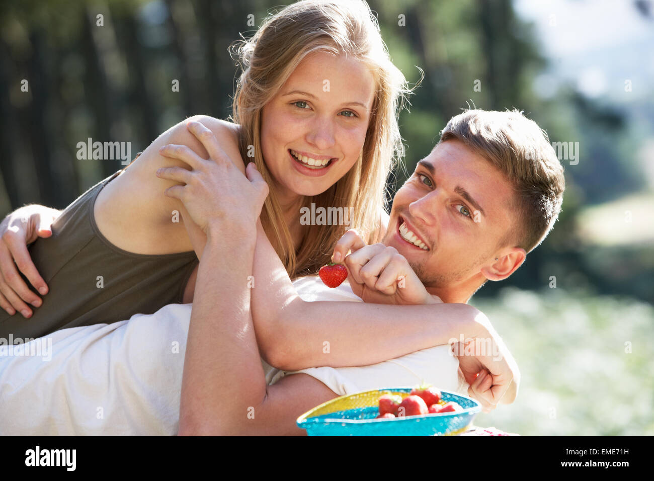 Young Couple Enjoying Picnic In Countryside Stock Photo