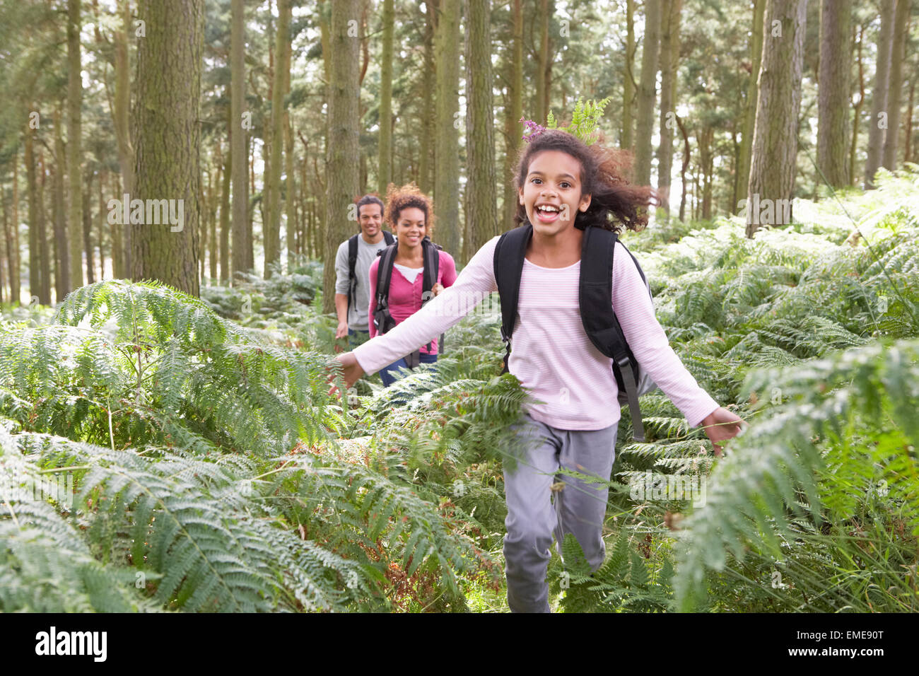 Family Group Hiking In Woods Together Stock Photo