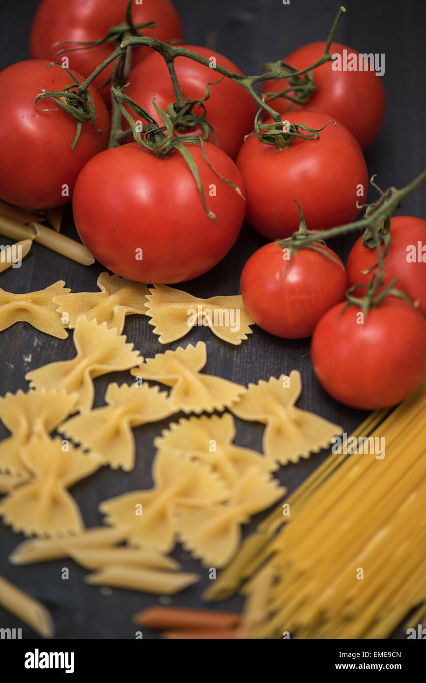 food background on rustic wood with pasta and tomatoes Stock Photo - Alamy