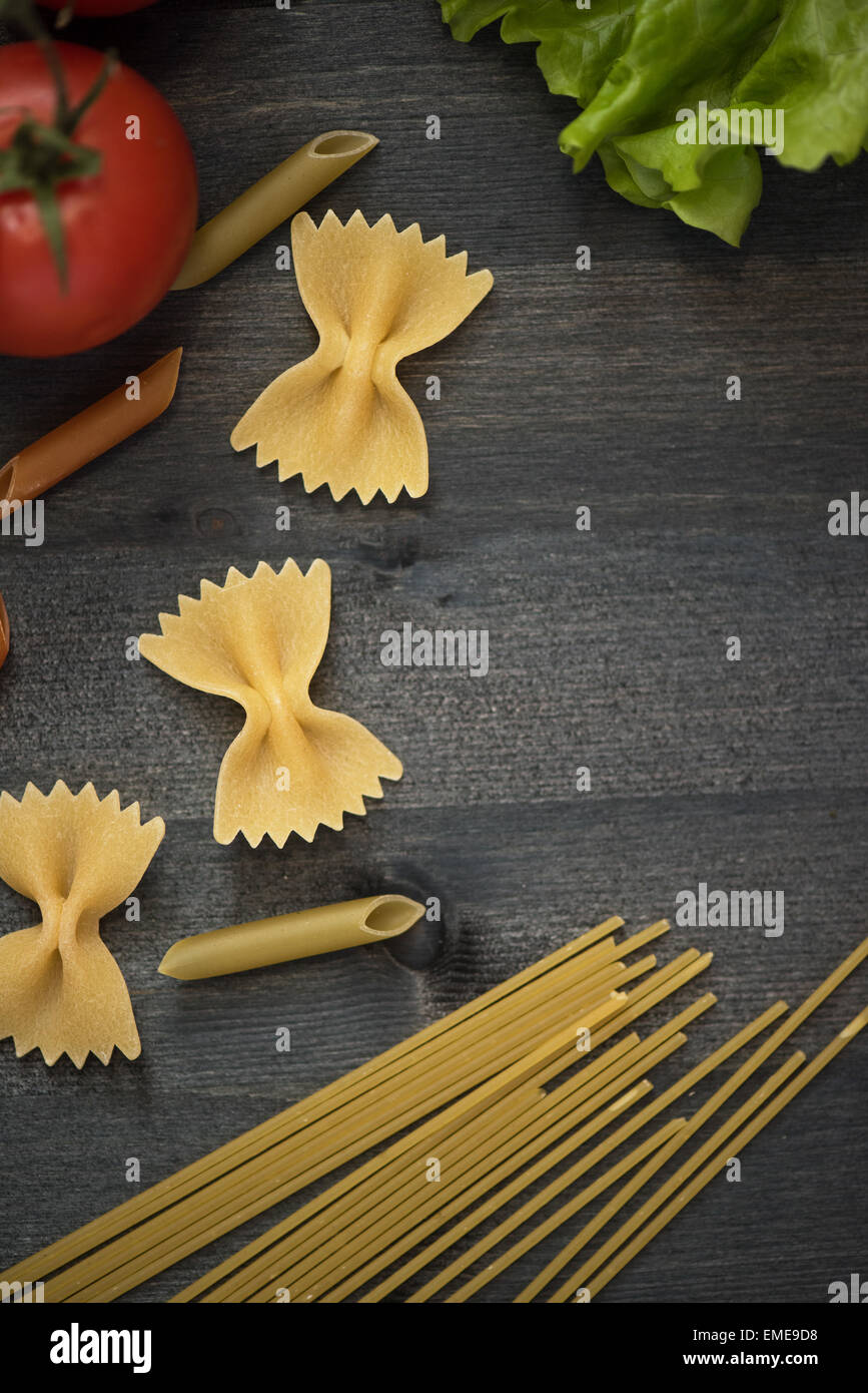 food background on rustic wood with pasta and tomatoes Stock Photo - Alamy