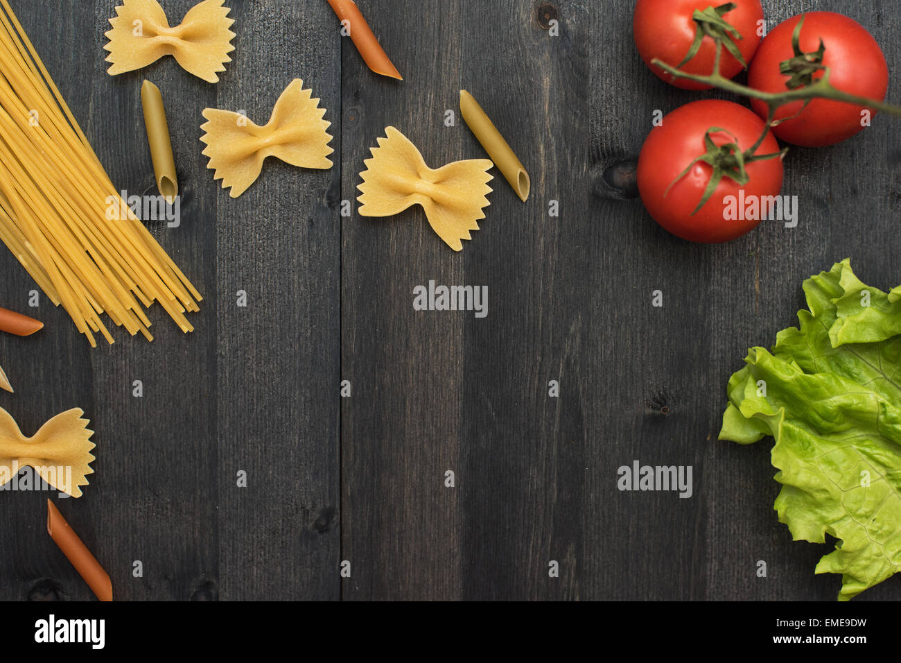 food background on rustic wood with pasta and tomatoes Stock Photo - Alamy