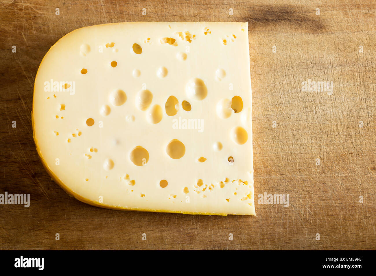 One piece of cheese over wood background Stock Photo