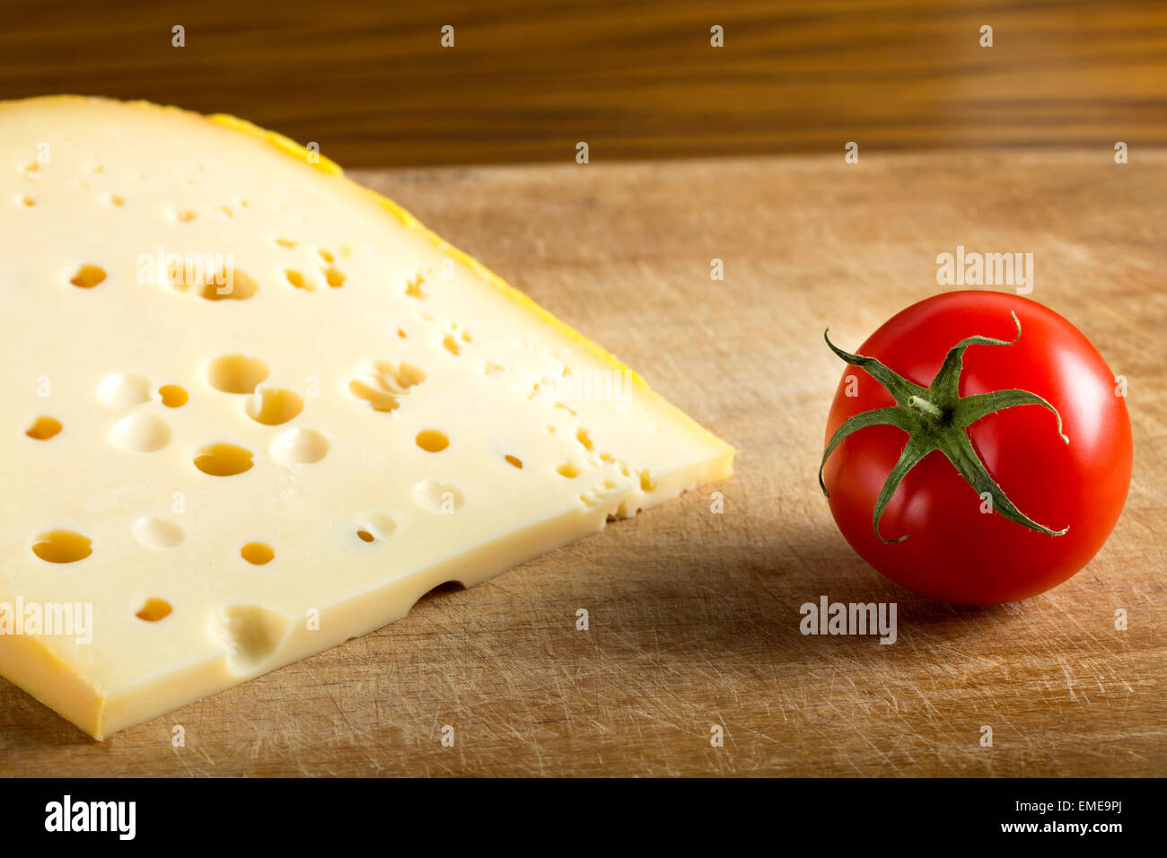 One piece of cheese over wood background Stock Photo